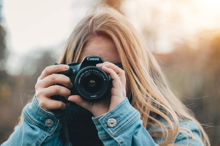 a woman taking a picture of herself taking a picture of herself