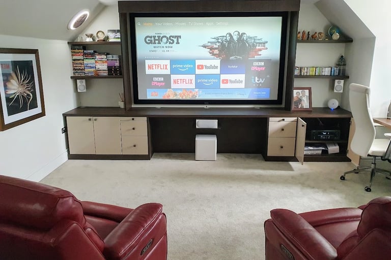 Fixed-frame 4K projector screen mounted in a dedicated home media room with professional optical ali
