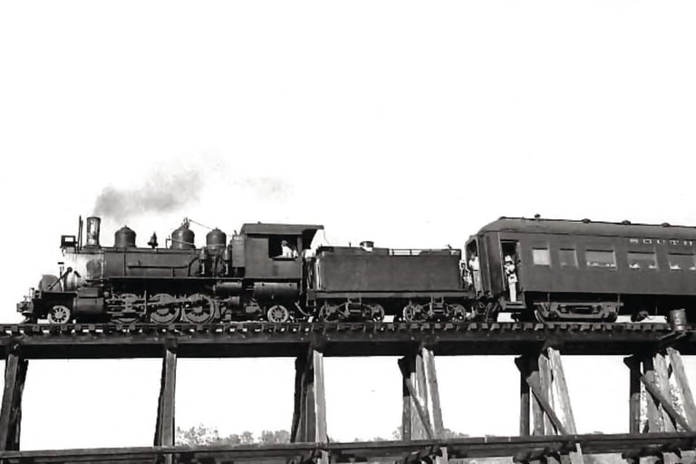 a train on a bridge over a river