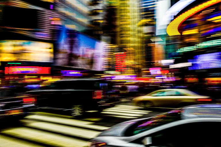 a city street scene with a car driving down the street