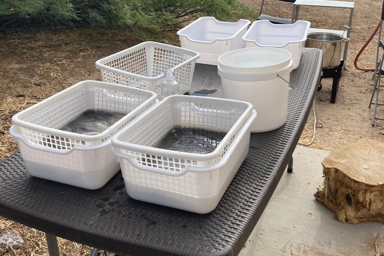 outdoor set up to wash wool in baskets