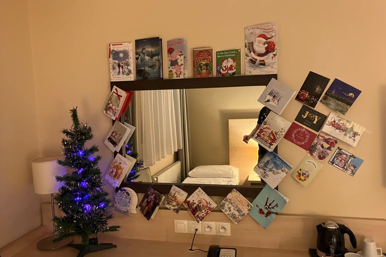 Christmas tree and christmas cards set up in hotel room at AquaPalace