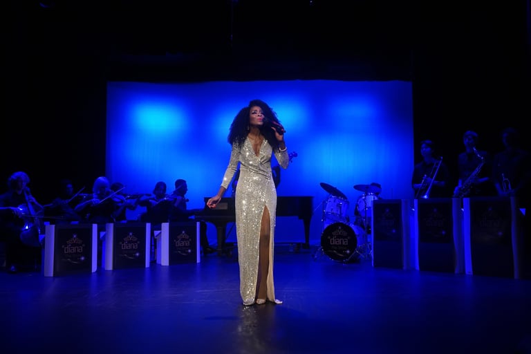 a woman in a gold dress standing in front of a stage