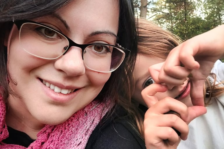 Doula Valentina -me- a woman in glasses and a pink scarf around her neck