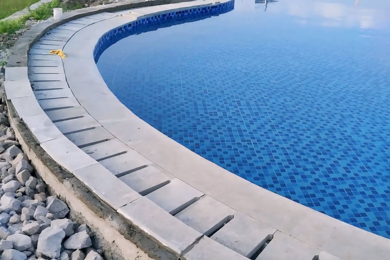 Kolam renang umum berbentuk lingkaran dengan keramik roman berwarna biru.