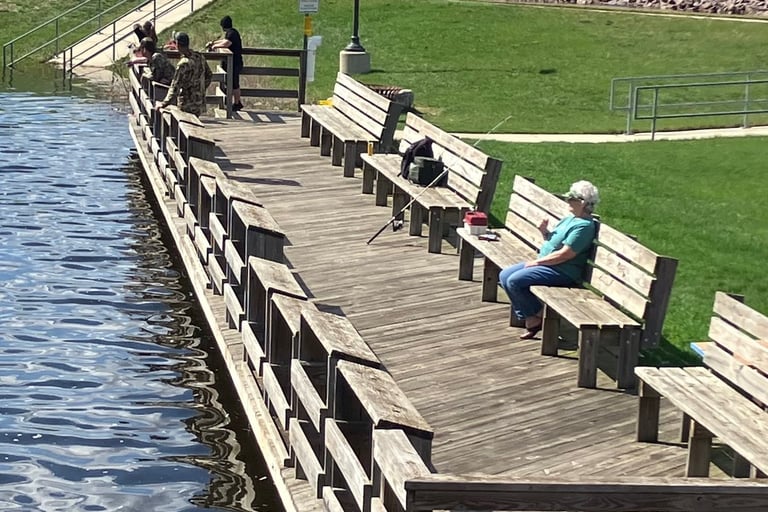 A woman watches the Fox River from a fishing dock in Montello, Wisconsin