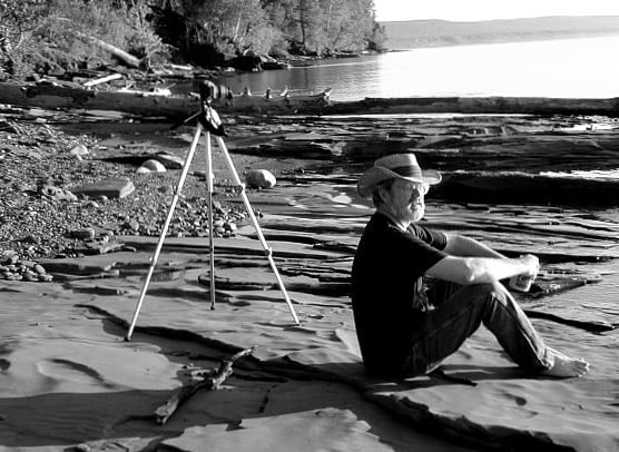 Photographer sitting on Lake Superior shore