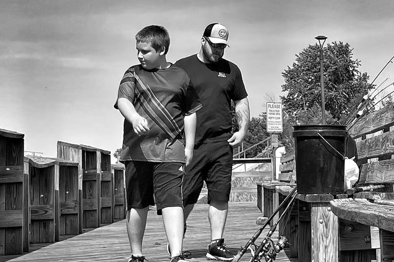 A man and boy come to fish the Fox River at the Montello Wisconsin dam. 