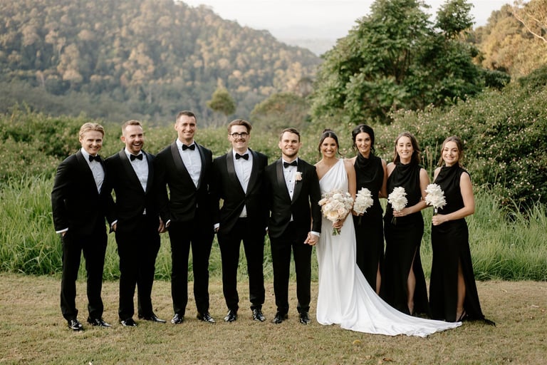 Wedding party at venue standing for photographer