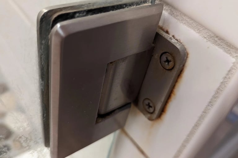 Rusty Hinge in bathroom partition
