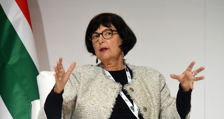 a woman in a white jacket and glasses