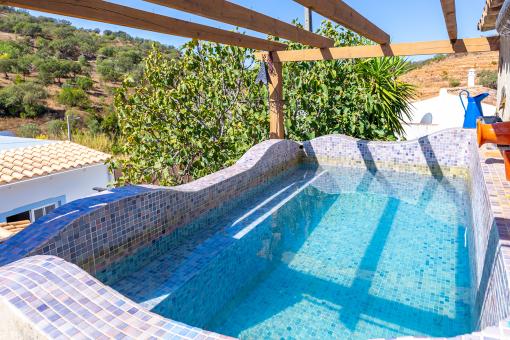 a pool with a wooden deck and a pool