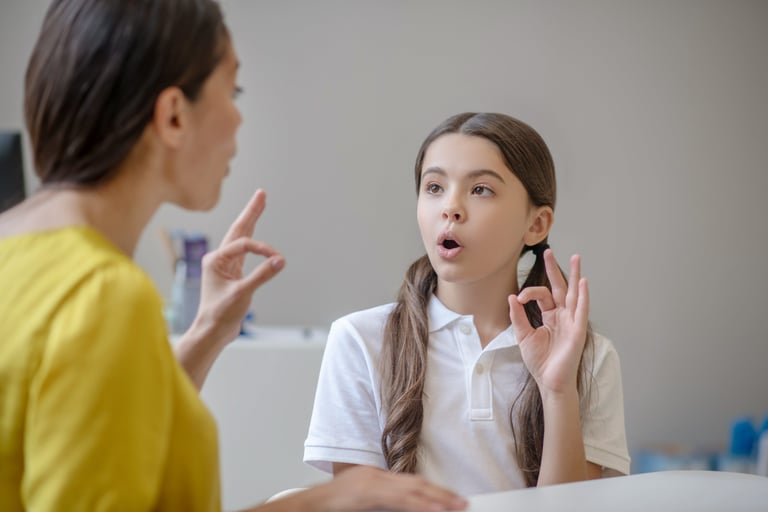 a woman talking on her cell phone while holding a cell phone