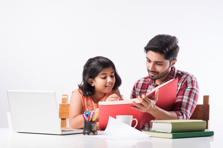a man and a little girl are sitting at a table