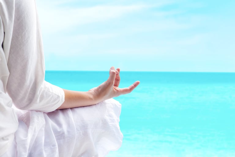 a person sitting on a bench with their hands up