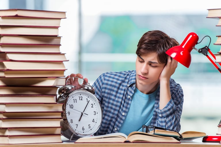 a man sitting at a desk with a clock and a clock