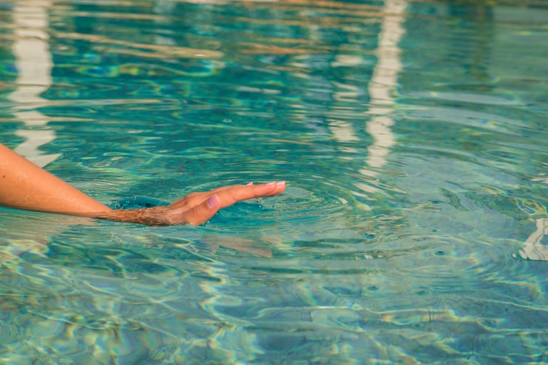 a person holding a frisbee in a pool