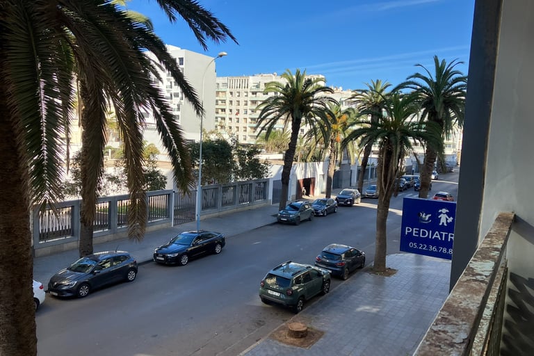 a street scene with cars parked on the side of the road