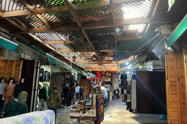a man standing in a market place with a lot of people