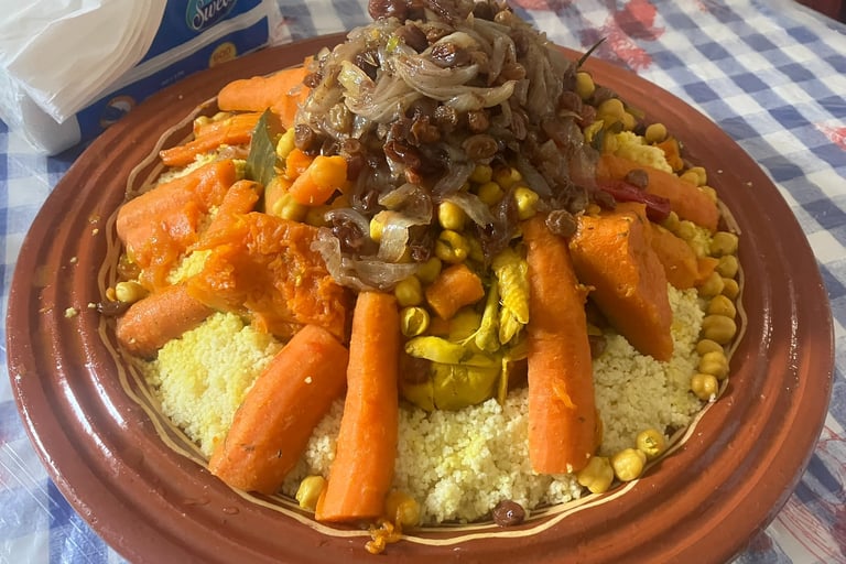 a plate of couscous with carrots and vegetables
