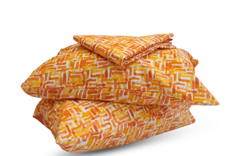 a stack of pillows with a pattern on them- cotton bedsheet