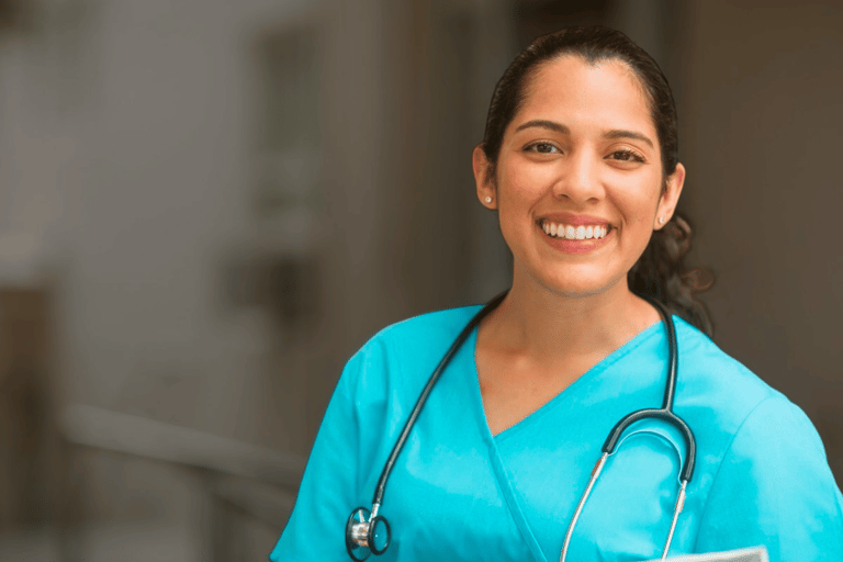 a nurse in blue scrubs with a stethoscope