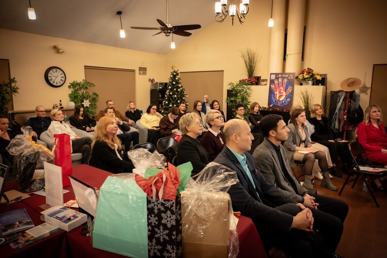 a group of people sitting in a room with christmas presents