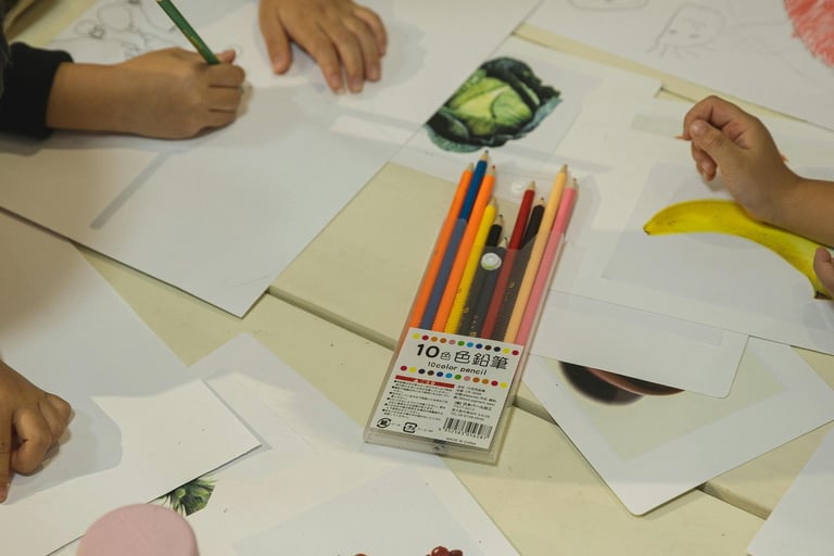 a group of children's hands are drawing on paper