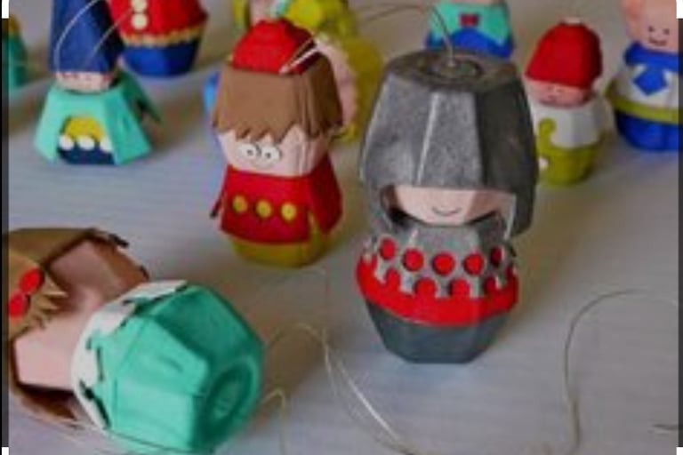 a group of paper mache dolls with a paper doll