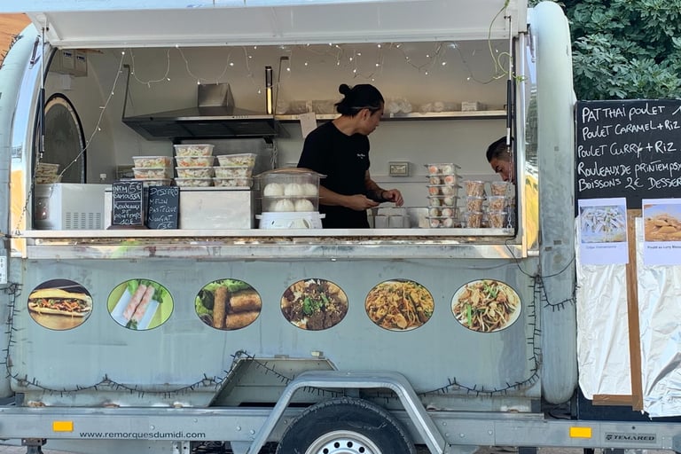 a man is standing in front of a food truck