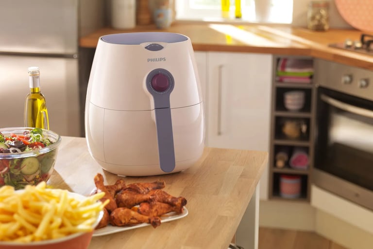 a kitchen counter top with a bowl of fries and a bowl of fries with an Air fryer on the center
