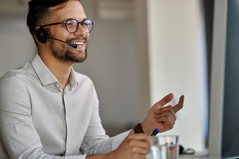 a man with a headset and a headset on a computer