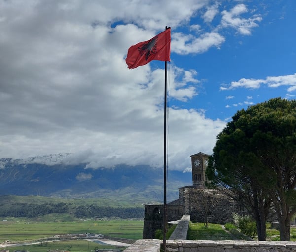 a albanian flag flying in the wind on a sunny day