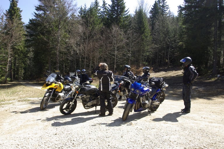 a group of people standing around a group of motorcycles