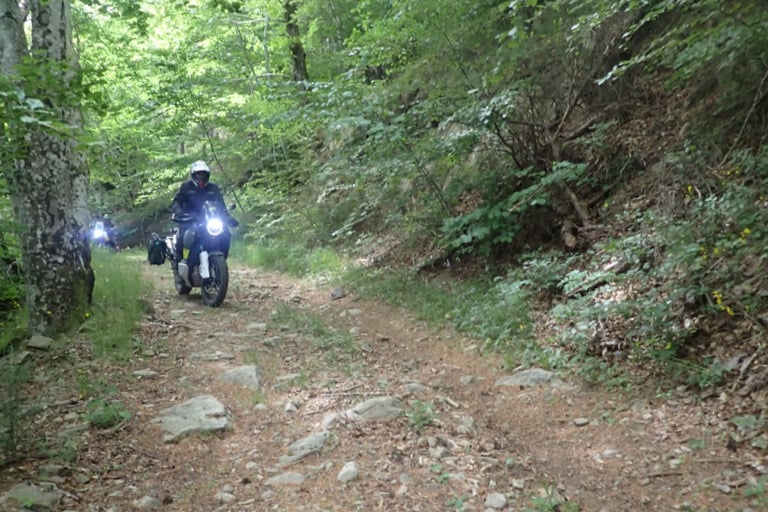 a person riding a motorcycle on a dirt road