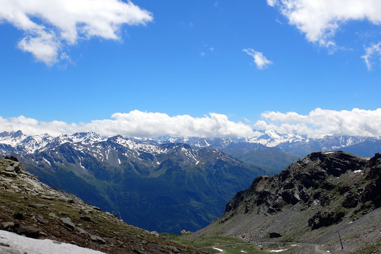 a person on a mountain with a sky background