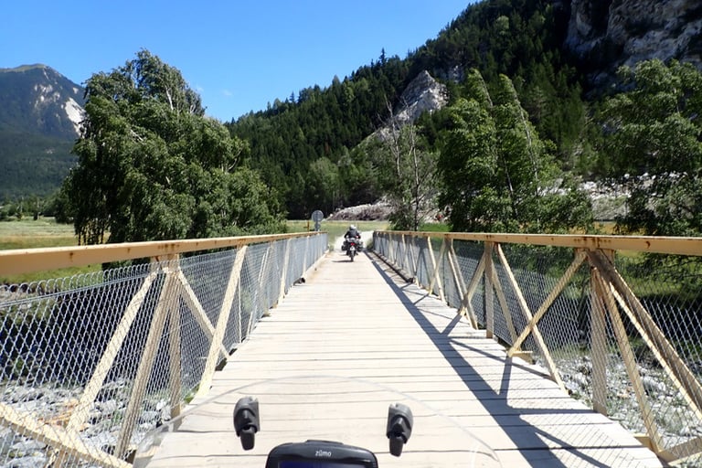a motorcycle on an old bridge over a river