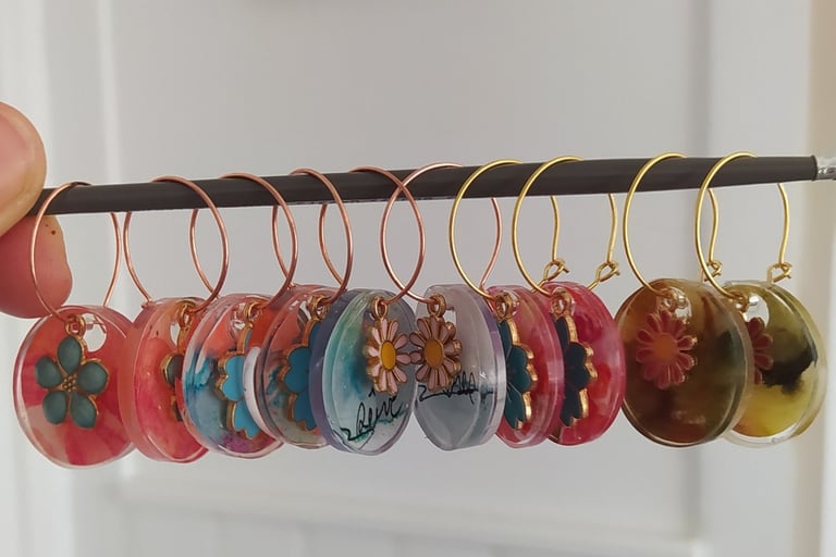 a person holding a bunch of buttons and earrings