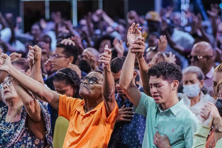 a group of people standing in a crowd worshipping God