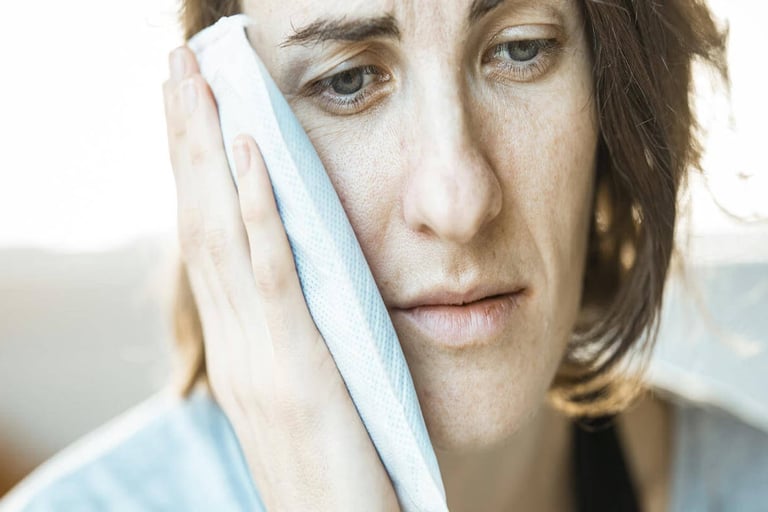 A woman with a towel on her head, in pain