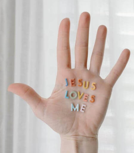 a person's hand with the words jesus loves me written on it