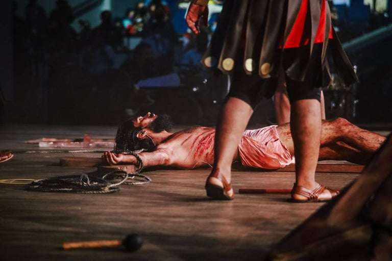 a man (Jesus) laid down on the floor beaten with blood on his body.