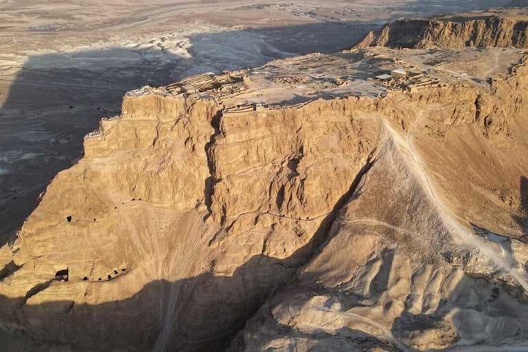 a mountain view of a cliff face in the desert