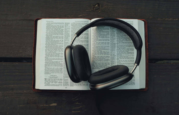 Open Bible showing Psalms 91–92 with headphones resting on its pages.