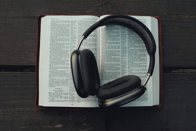 a bible opened with a headphones