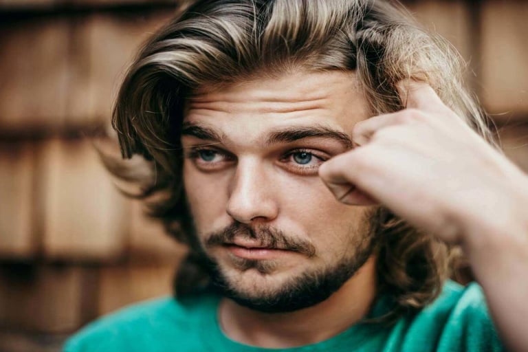 Thoughtful young man looking uncertain and deep in reflection