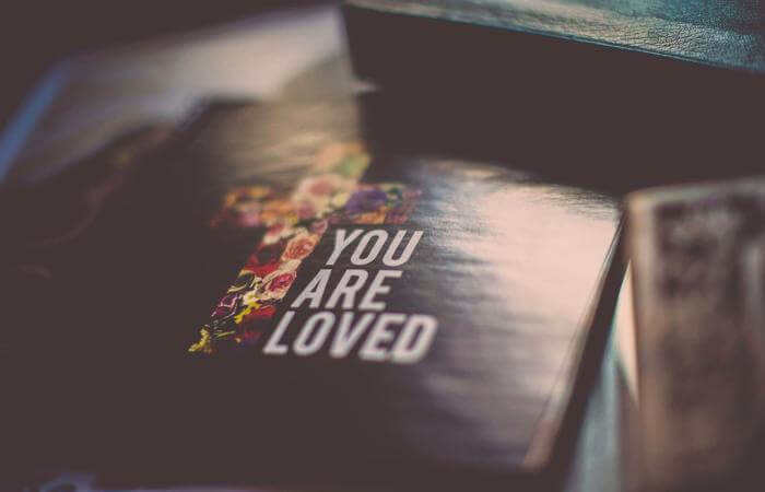Book with the words “You are loved” on the cover.