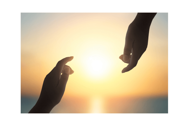 two hands reaching for the sun in the sky at golden hour