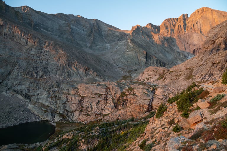 Sunrise alpenglow on the Majestic Longs Peak diamond face, towering above Columbine Falls 