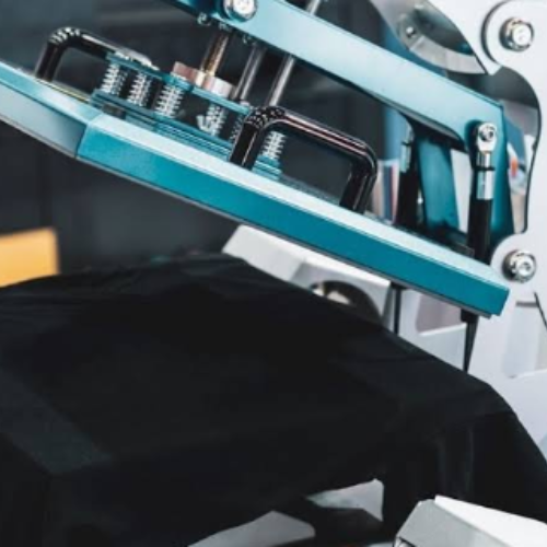A commercial heat press pressing a t-shirt